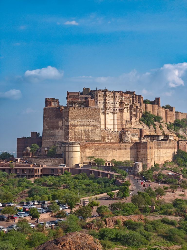 Stunning view of Mehrangarh Fort in Jodhpur, showcasing its historical architecture under a vibrant blue sky.